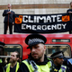Extinction Rebellion protestors stop trains at Canary Wharf station in London on April 17, 2019.